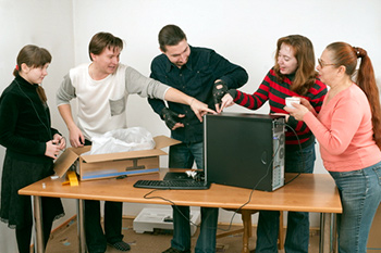 Family unwrapping a new computer